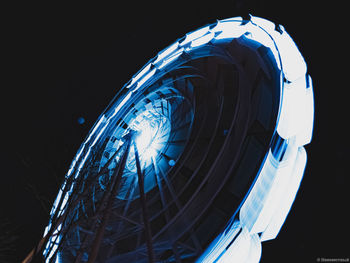 Low angle view of ferris wheel against sky at night