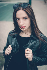 Portrait of beautiful young woman with hand