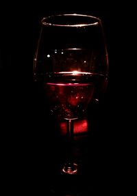 Close-up of wine glass against black background