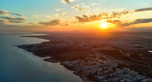 Aerial view of sea against sky during sunset