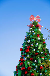 Close-up of christmas tree against clear blue sky