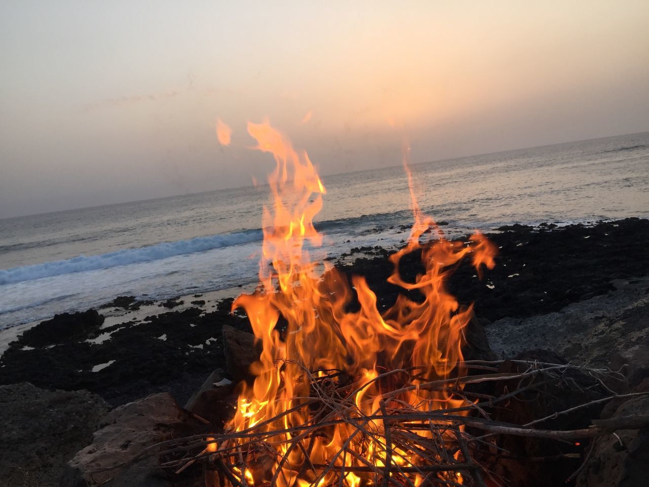 water, sea, sunset, scenics, horizon over water, beauty in nature, tranquil scene, beach, tranquility, nature, sky, orange color, idyllic, motion, wave, shore, heat - temperature, sun, rock - object, outdoors