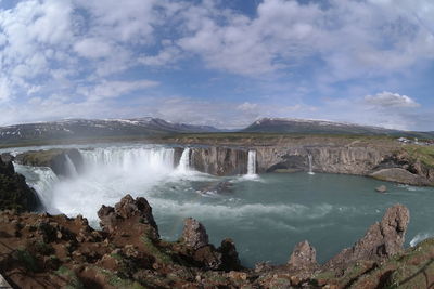 Panoramic view of waterfall against sky