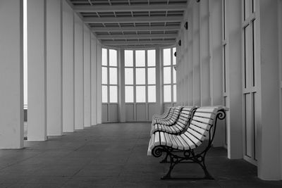 Empty chair in corridor of building