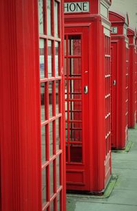 Red telephone booths by street