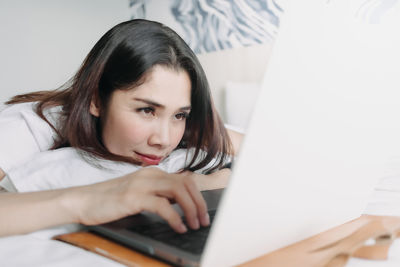 Young woman using laptop at home