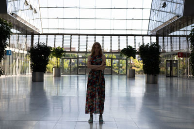 Portrait of woman standing on tiled floor