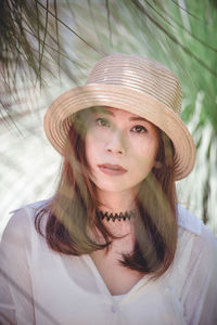 Portrait of beautiful young woman in hat