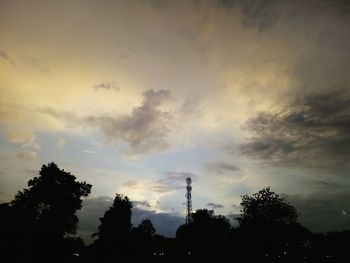 Low angle view of silhouette trees against sky
