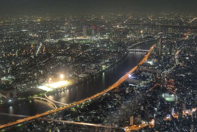 Aerial view of city lit up at night