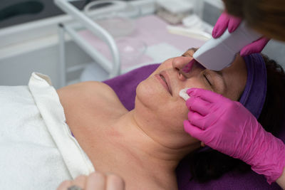 Midsection of doctor examining patient at clinic