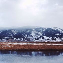 Scenic view of snow covered mountains against sky