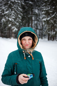 Portrait of smiling woman in snow