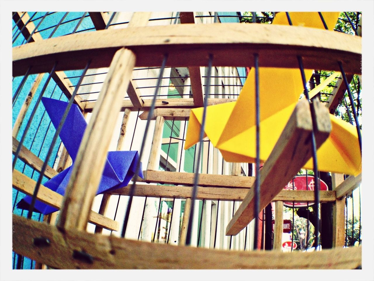 built structure, multi colored, architecture, yellow, building exterior, low angle view, blue, colorful, flag, day, sunlight, wood - material, outdoors, parasol, auto post production filter, sky, no people, umbrella, protection, transfer print