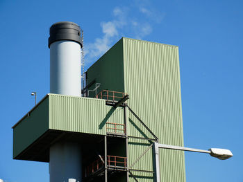 Low angle view of smoke stack against sky