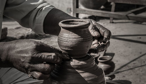 Cropped hands of porter shaping earthenware