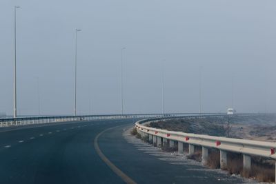 Bridge over road against clear sky