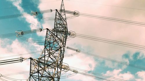 Low angle view of electricity pylon against sky