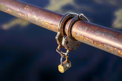 Close-up of handcuffs on metal