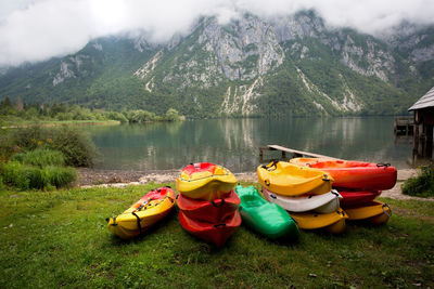 Boats on lake against mountain range