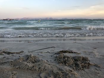 Scenic view of beach against sky during sunset