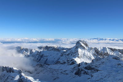 Aerial view of snowcapped mountains against sky