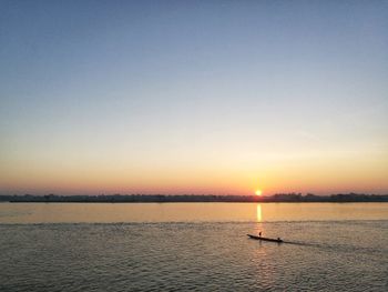 Scenic view of sea against clear sky during sunset