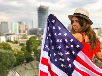 Low angle view of woman against buildings in city