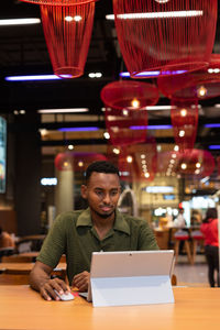 Woman using laptop at cafe