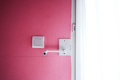Close-up of red door on building wall