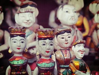 Close-up of antique figurines for sale at market stall