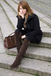 Young woman sitting on steps