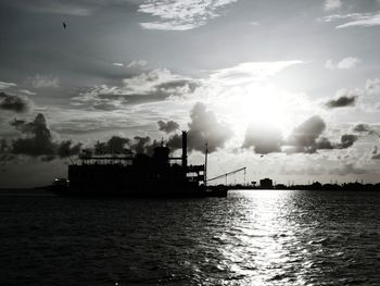 Reflection of clouds in sea at sunset