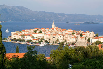 Scenic view of sea and buildings in city