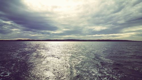 Scenic view of sea against cloudy sky