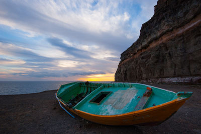 Boats moored on sea shore against sky