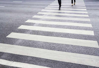 Low section of people walking on road