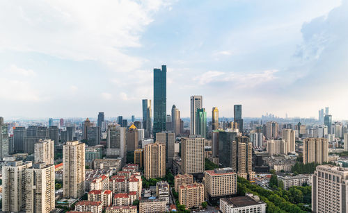 Aerial view of modern buildings in city against sky