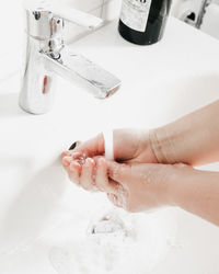 High angle view of woman hands in bathroom