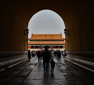 Group of people walking in historical building