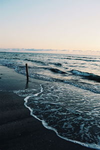 Scenic view of sea against clear sky during sunset