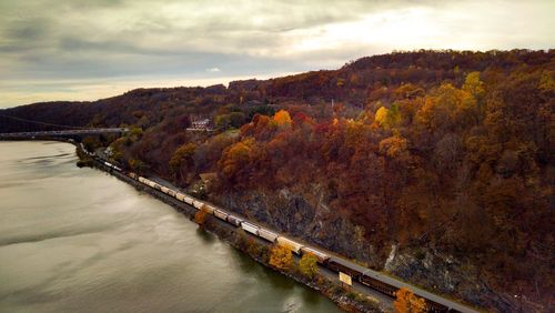 Bridge over river against sky during sunset