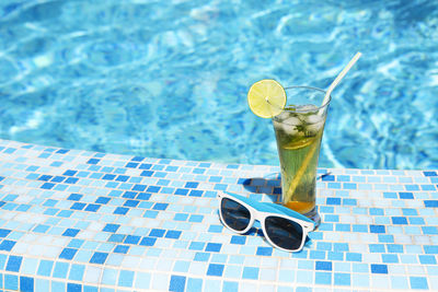 High angle view of drink on table at swimming pool