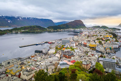 Skyline and cityscape of alesund, norway, on a cloudy day. ocean bay in the background, bright house