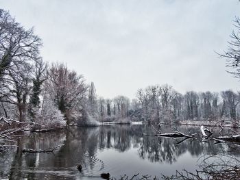 Scenic view of lake against sky during winter