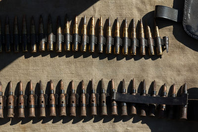 High angle view of gun cartridge arranged on cloth