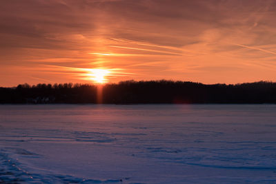 Scenic view of snow covered landscape during sunset