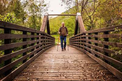 Full length of man standing on footbridge