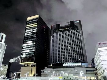 Low angle view of illuminated buildings against sky at dusk