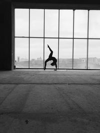 Full length of man in window against sky